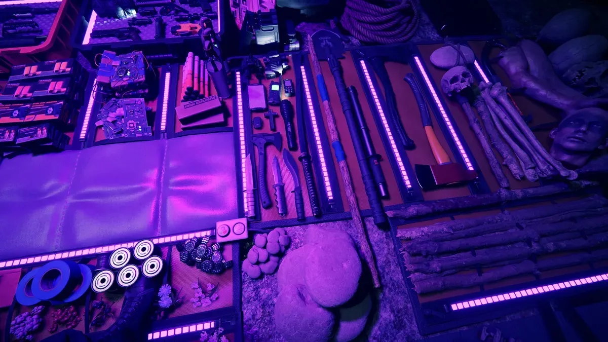 Tools and crafting items on a tarp in purple light in Sons of the Forest.