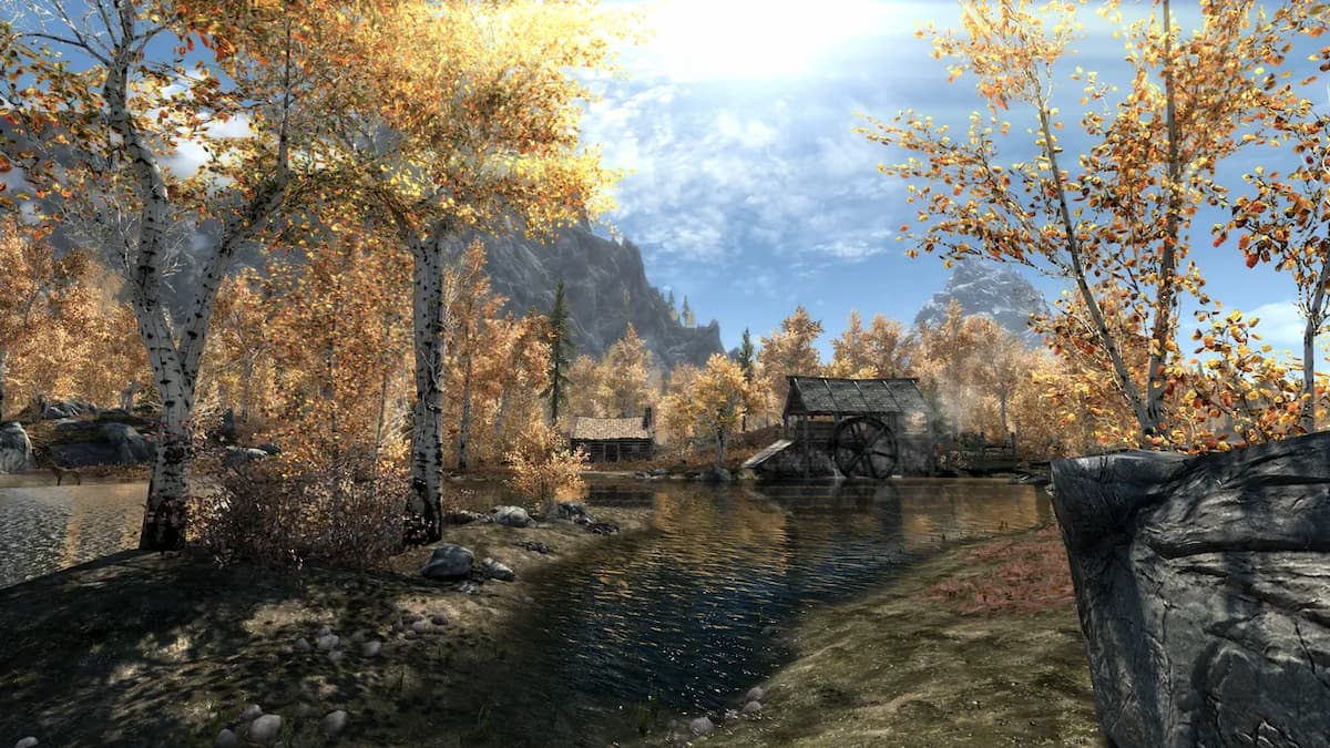 autumn landscape in skyrim of yellow leaf trees and a small hamlet