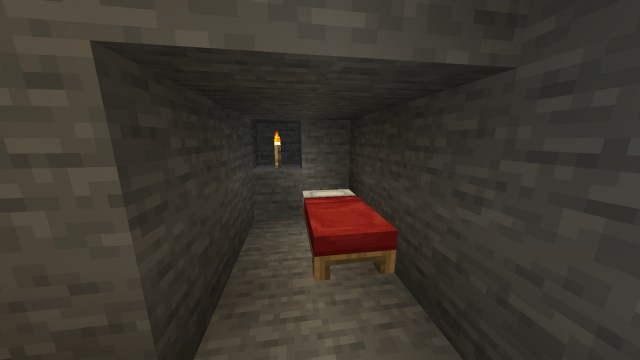 A bed set down in a small alcove.