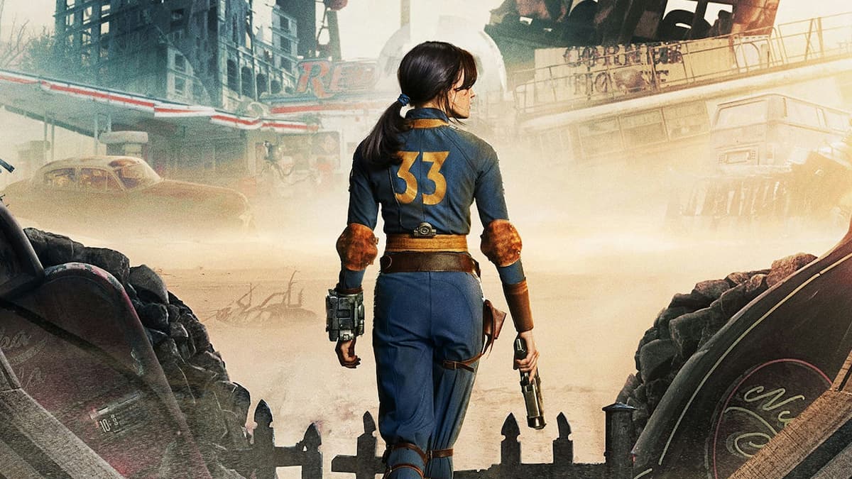 Lucy wearing Vault 33 suit with a gun in the Fallout TV series. 