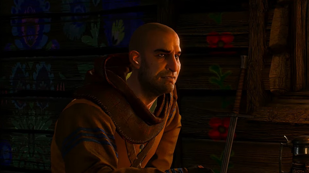 Gaunter sitting at a table in a tavern