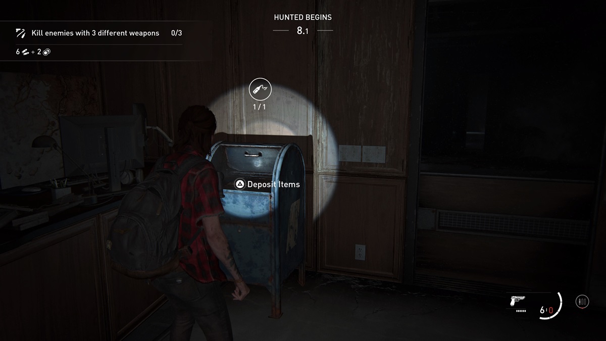Ellie standing in front of a Dead Drop during a Hunted mission in No Return.