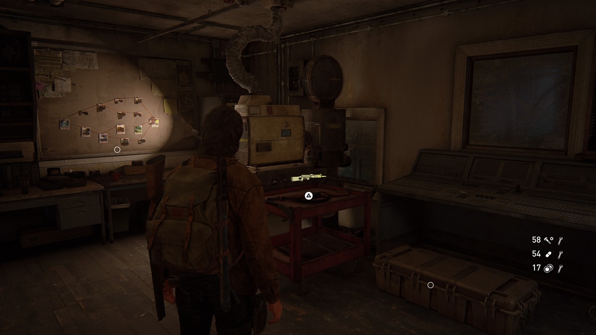Joel looking at a Dead Drop gun reward at base in TLoU2 No Return.