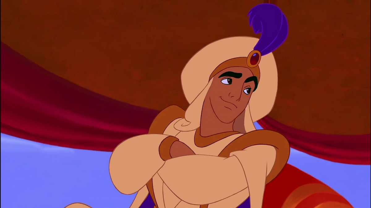 Aladdin in a sultan outfit with arms crossed