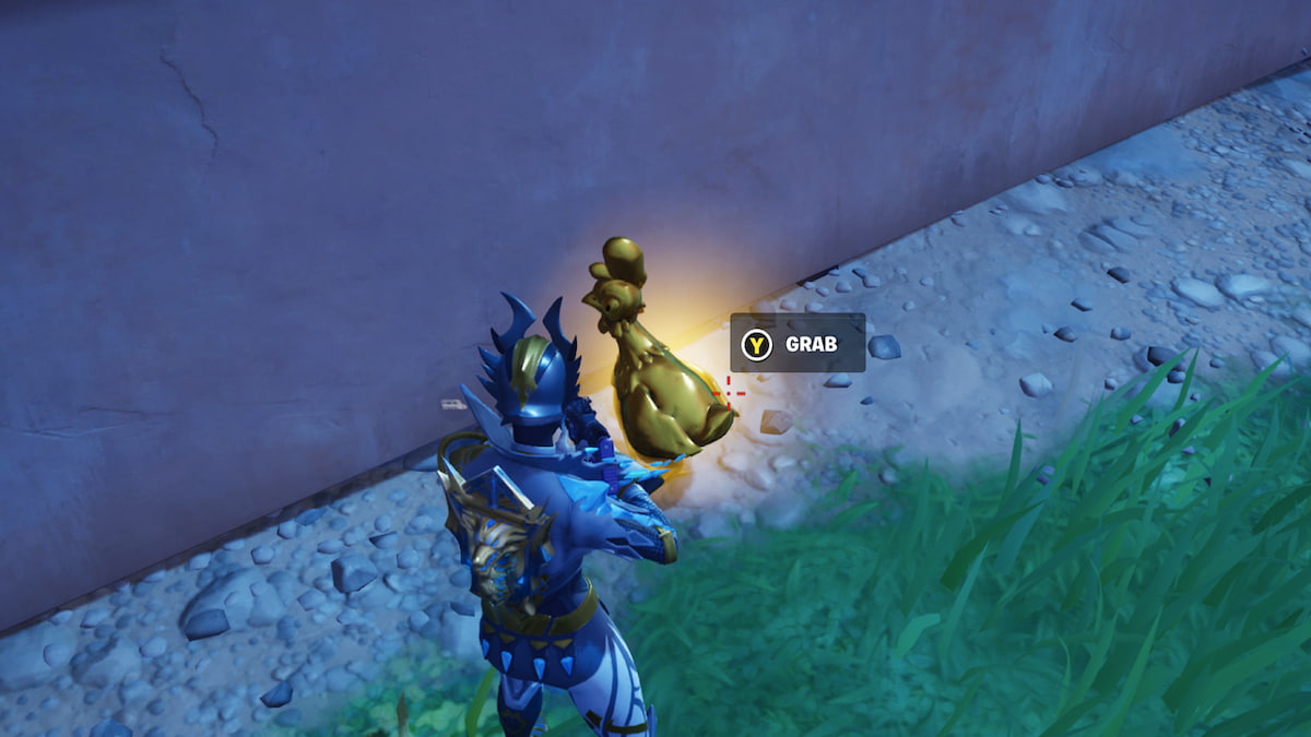 Player in front of a golden chicken against a wall with the grab prompt above it