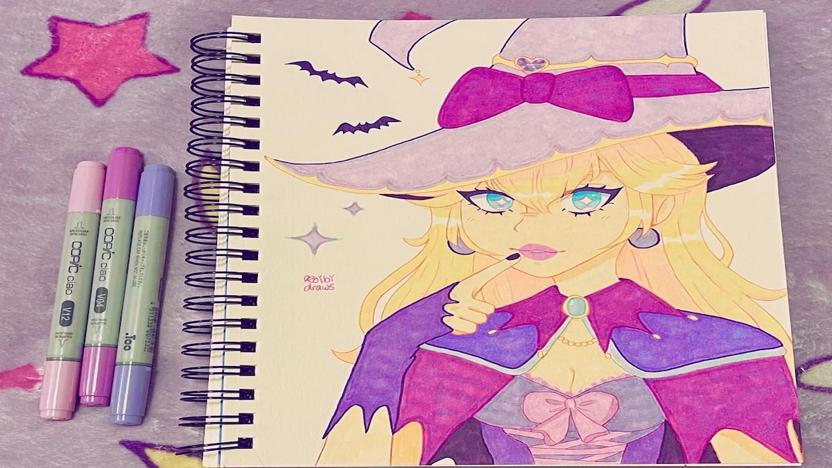 Art of Princess Peach in witch hat and purple cloak and gloves, bats and sparkles around her on a notebook with markers beside it 