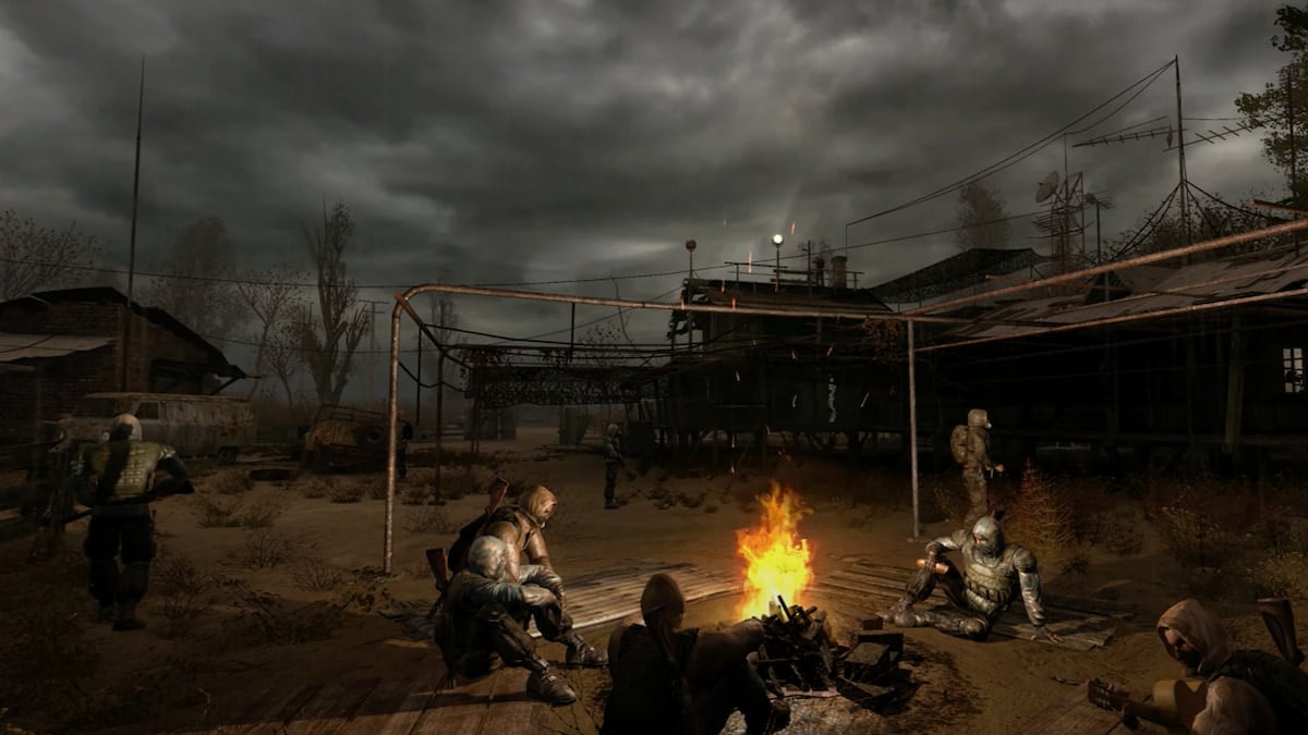 characters sitting around a campfire in S.T.A.L.K.E.R