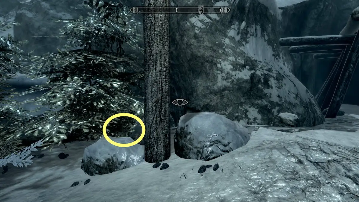 Dawnstar mine, rocks and trees beside the entrance and circled spot where the invisible chest appears