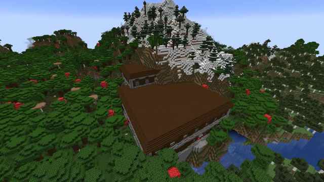 A Minecraft Woodland Mansion partially inside of a Snowy Peaks mountain