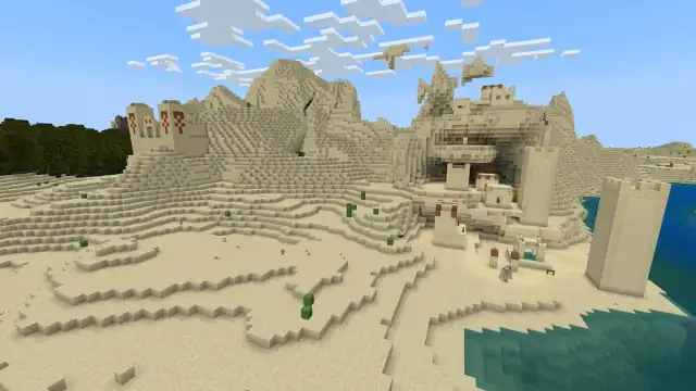 A Minecraft Desert Village built on different Y-levels next to a tall Desert Temple on the side of a hill