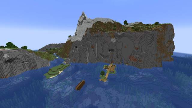 A set of sheer stony cliffs on the coast of a Minecraft ocean with a shipwreck and a Plains Village