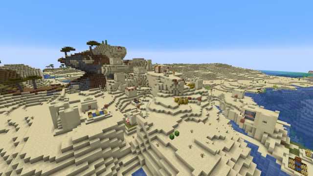 A two-level Desert Village on the edge of a Windswept Savanna biome in Minecraft