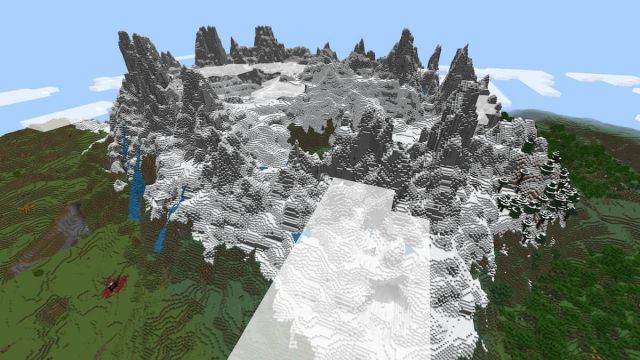 A towering Jagged Peaks mountain with a ruined Nether portal in Minecraft