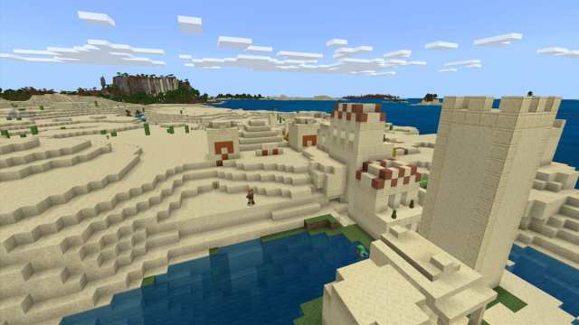 A Desert Temple half-buried in the sand around a Desert Village in Minecraft