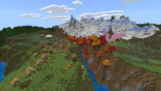 A Pillager Outpost on the side of a Minecraft mountain in front of a gorge that has a Plains Village on one side and a Dappled Forest and a Cherry Grove on the other.