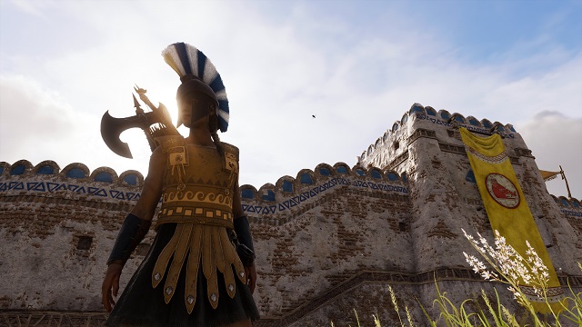A female warrior wearing gold armor and an axe stands in front of a fortress