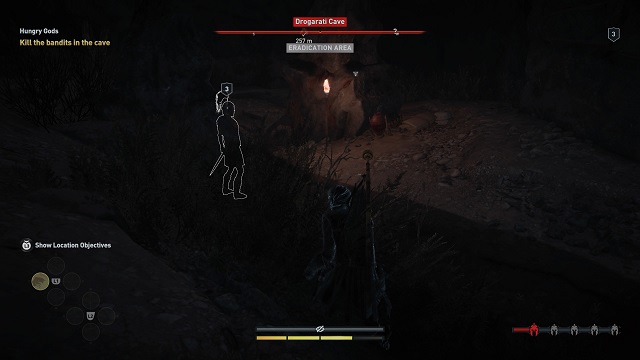 Kassandra sneaks up behind and enemy in a cave