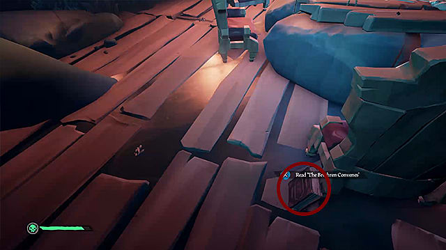 A red journal propped up against a wooden chair leg on a pirate ship.