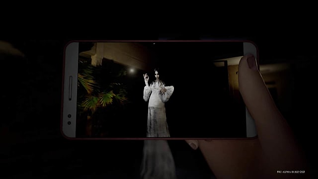 A cellphone captures a creepy image of a white angel-like being in DreadOut 2. 