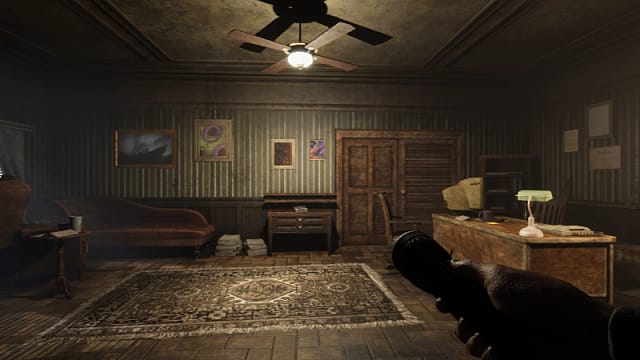Player character holding a flashlight in a well-lit home office.
