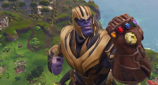 Thanos float above the Fortnite map holding the Infinity Gauntlet in front of his face