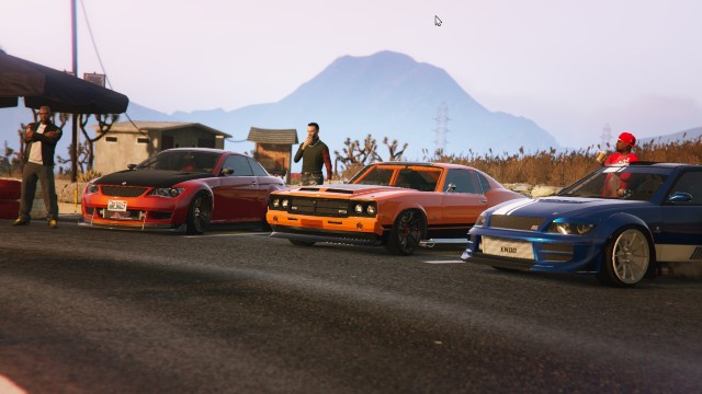 A car meet in the desert in GTA Online with three sports cars.