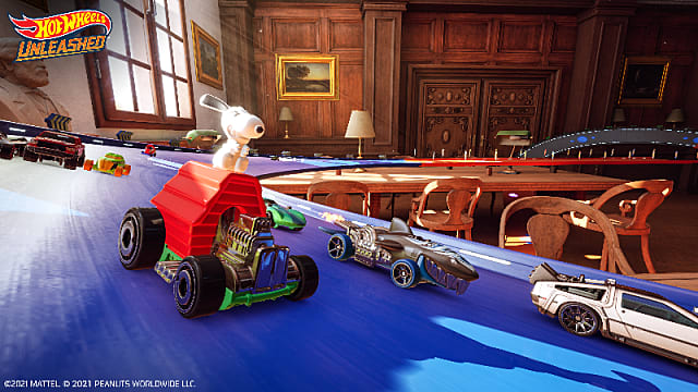 Snoopy car racing a shark car, Delorean, and others on a blue track in a study.