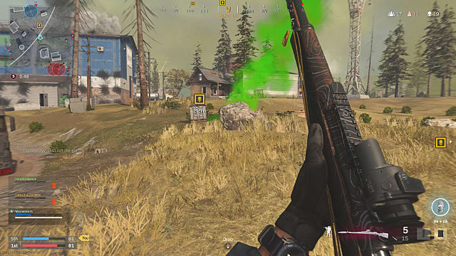 A player holding a marksman rifle up, looking at the green smoke of a skull crate on the edge of a grassy hill.