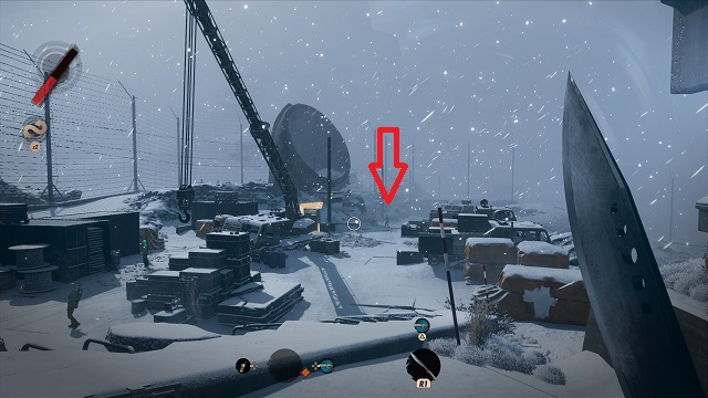 A construction area in the snowy afternoon section of The Complex, player's machete in right side of frame.