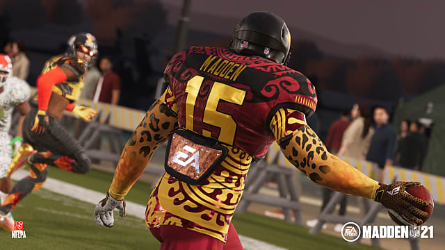 A custom player in cheetah sleeves, red and gold jersey stares at receiver, ready to throw.