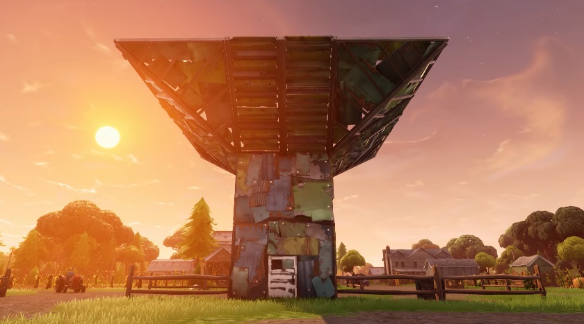 a fortification in Fortnite in front of a setting sun