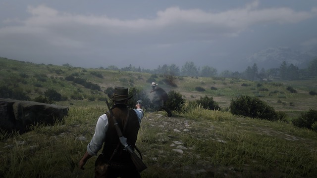 Arthur Morgan shoots a bandit with a Cattleman Revolver on a grassy knoll