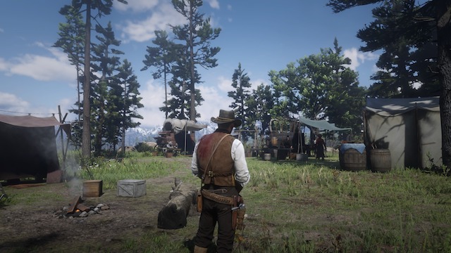 Arthur Morgan, with a bloody shoulder, looks out at the Horseshoe Overlook camp next to a fire