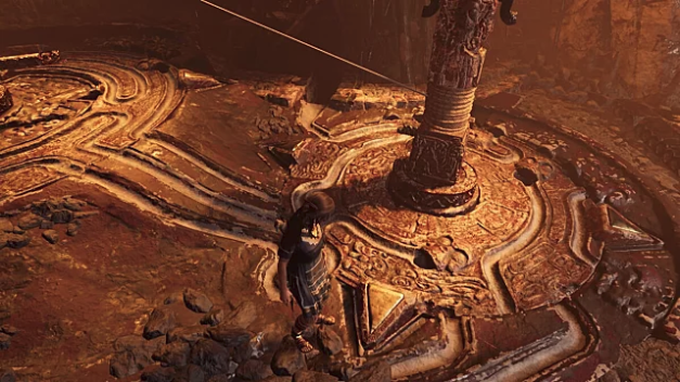 Lara Croft stands on a rotating brown floor with channels in it