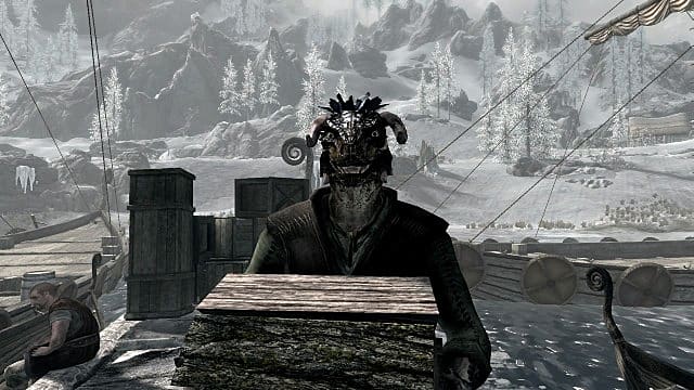 A male Argonian holding wood on a dock.