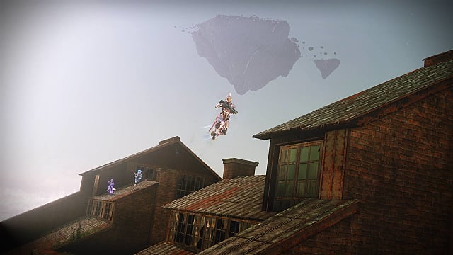 A Titan jumps between rooftops in the EAZ, with two other players behind them in the distance.